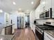 Modern kitchen featuring stainless steel appliances and granite countertops at 5935 Maidenstone Way, Palmetto, FL 34221
