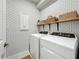 Laundry room with washer, dryer, and stylish shelving at 5935 Maidenstone Way, Palmetto, FL 34221