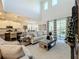 Open living room with hardwood floors, white cabinets, and island at 5935 Maidenstone Way, Palmetto, FL 34221
