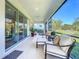 Bright screened porch with comfy seating and view at 5935 Maidenstone Way, Palmetto, FL 34221