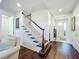 Open staircase with hardwood floors and white railing at 5935 Maidenstone Way, Palmetto, FL 34221