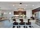 Modern kitchen with large island, stainless steel appliances, and dark wood cabinetry at 7506 Parkshore Dr, Apollo Beach, FL 33572