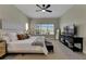 Spacious main bedroom with a king-size bed, large window and private access to patio at 7506 Parkshore Dr, Apollo Beach, FL 33572