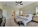 Large main bedroom with ceiling fan, king-size bed and access to en-suite bathroom at 7506 Parkshore Dr, Apollo Beach, FL 33572