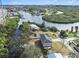 Aerial view of waterfront home and neighborhood, showcasing canal access at 9107 Brunswick Ln, Tampa, FL 33615