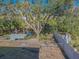 Private backyard with fenced area, dock access, and mature trees at 9107 Brunswick Ln, Tampa, FL 33615