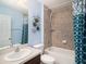 Clean bathroom with shower/tub combo and patterned shower curtain at 9107 Brunswick Ln, Tampa, FL 33615
