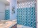 Clean bathroom with shower/tub combo and patterned shower curtain at 9107 Brunswick Ln, Tampa, FL 33615