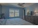 Comfortable bedroom with a king-size bed and large window at 9107 Brunswick Ln, Tampa, FL 33615