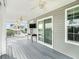 Large deck with ceiling fan and water view at 9107 Brunswick Ln, Tampa, FL 33615