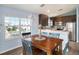 Dining area with wooden table and blue chairs, overlooking a yard at 9107 Brunswick Ln, Tampa, FL 33615