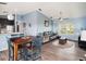 Bright dining area with wooden table and blue chairs, adjacent to living room at 9107 Brunswick Ln, Tampa, FL 33615