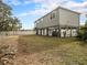 Elevated home with backyard and fence at 9107 Brunswick Ln, Tampa, FL 33615