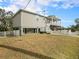 Elevated home with front porch and yard at 9107 Brunswick Ln, Tampa, FL 33615