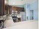 L-shaped kitchen with stainless steel appliances and wood cabinets at 9107 Brunswick Ln, Tampa, FL 33615