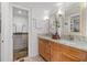 Bathroom with double vanity with granite counters and separate toilet room at 16308 Gulf Blvd # 303, Redington Beach, FL 33708
