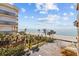 Scenic beach view of condos, beach, ocean, and palm trees at 16308 Gulf Blvd # 303, Redington Beach, FL 33708