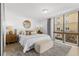 Bright bedroom with a large window, stylish furnishings, and a comfortable bed at 16308 Gulf Blvd # 303, Redington Beach, FL 33708