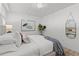 Bedroom features an upholstered bed frame, modern decor, and ample light at 16308 Gulf Blvd # 303, Redington Beach, FL 33708