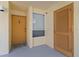 Welcoming entrance featuring a wooden door, small window, and neutral color palette at 16308 Gulf Blvd # 303, Redington Beach, FL 33708