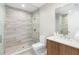 Modern bathroom with a glass-enclosed shower, neutral tile, and a contemporary vanity at 5120 Marina Way # 112, Tampa, FL 33611