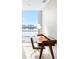 Well-lit home office area with a stylish wooden desk and a large window offering views of the water at 5120 Marina Way # 112, Tampa, FL 33611