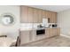 Modern kitchen with light wood cabinetry, stainless steel appliances, and white countertops at 5120 Marina Way # 112, Tampa, FL 33611