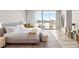 Serene main bedroom with a large bed, stylish seating, and sliding glass doors to a balcony overlooking the water at 5120 Marina Way # 112, Tampa, FL 33611