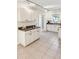 View of kitchen with white cabinets and tile floor at 813 89Th N Ave, St Petersburg, FL 33702