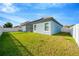 Large backyard with grassy lawn and screened patio at 11926 Cinnamon Fern Dr, Riverview, FL 33579