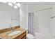 Clean bathroom with shower/tub combo and granite vanity at 11926 Cinnamon Fern Dr, Riverview, FL 33579