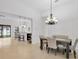 Bright dining room with chandelier and view into kitchen at 11926 Cinnamon Fern Dr, Riverview, FL 33579