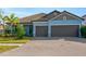 Two-car garage and light blue exterior at 11926 Cinnamon Fern Dr, Riverview, FL 33579