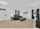 Spacious living room with leather seating and large windows at 11926 Cinnamon Fern Dr, Riverview, FL 33579