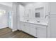 A bright bathroom with a double vanity and a glass shower enclosure at 1521 Preston S St, St Petersburg, FL 33712
