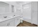Bright bathroom featuring a double sink vanity, modern fixtures, and a tub-shower combo at 1521 Preston S St, St Petersburg, FL 33712