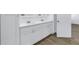 Bathroom featuring a double sink vanity with white cabinets, quartz countertops, wood-look flooring, and modern fixtures at 1521 Preston S St, St Petersburg, FL 33712