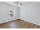 A serene bedroom featuring natural light and wood-look flooring at 1521 Preston S St, St Petersburg, FL 33712