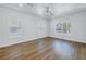Bright bedroom featuring hardwood floors, a ceiling fan, and bright windows at 1521 Preston S St, St Petersburg, FL 33712