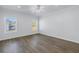A sunlit bedroom with wood-look flooring and dual windows at 1521 Preston S St, St Petersburg, FL 33712