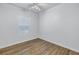 Compact bedroom featuring hardwood floors, a ceiling fan, and bright window at 1521 Preston S St, St Petersburg, FL 33712