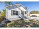 Exterior view of a white home featuring gray trim and a front porch at 1521 Preston S St, St Petersburg, FL 33712