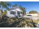 Charming home showcasing a white exterior, covered front porch, and spacious driveway at 1521 Preston S St, St Petersburg, FL 33712