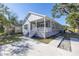Welcoming home with a covered front porch, manicured lawn, and ample parking space at 1521 Preston S St, St Petersburg, FL 33712