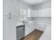 Bright kitchen featuring stainless steel appliances, white cabinets, and a window over the sink at 1521 Preston S St, St Petersburg, FL 33712