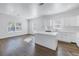 Sunlit open kitchen with white cabinets and a central island at 1521 Preston S St, St Petersburg, FL 33712