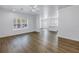 Open-concept living space flowing to the kitchen featuring hardwood floors and bright windows at 1521 Preston S St, St Petersburg, FL 33712