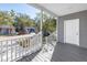 Front porch featuring gray siding, wood-look flooring, and white railings at 1521 Preston S St, St Petersburg, FL 33712