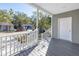 Front porch featuring gray siding, wood-look flooring, and white railings at 1521 Preston S St, St Petersburg, FL 33712