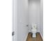 Small toilet room featuring white walls, wood look floors, toilet and hardware at 1521 Preston S St, St Petersburg, FL 33712